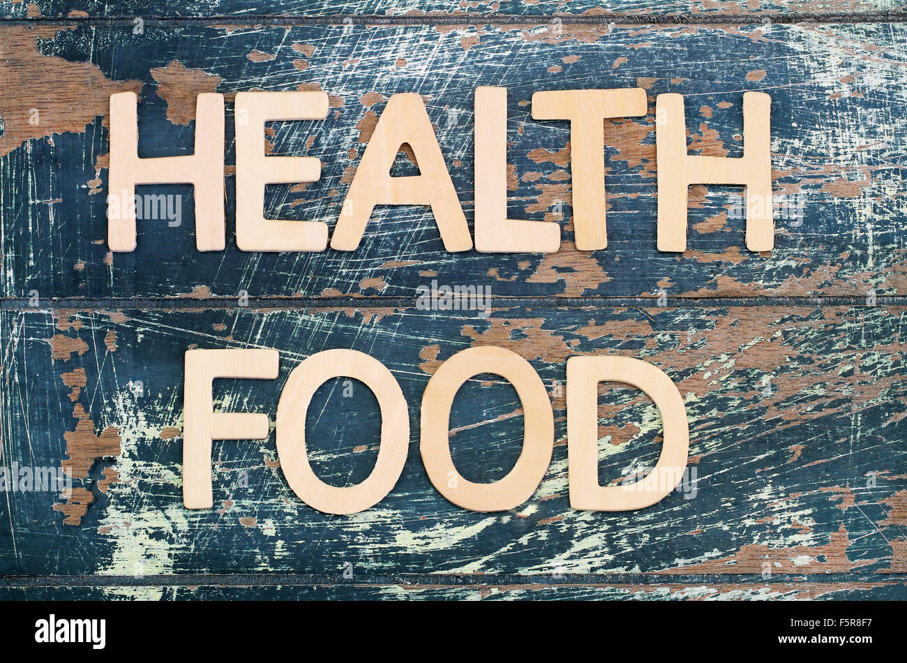 Health food written with wooden letters on rustic surface Stock Photo
