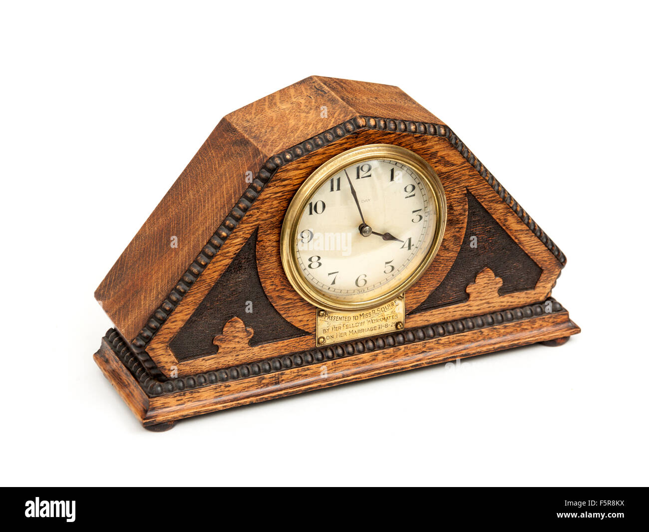 Antique (1929) Art Deco wooden mantel clock with French mechanism. Stock Photo