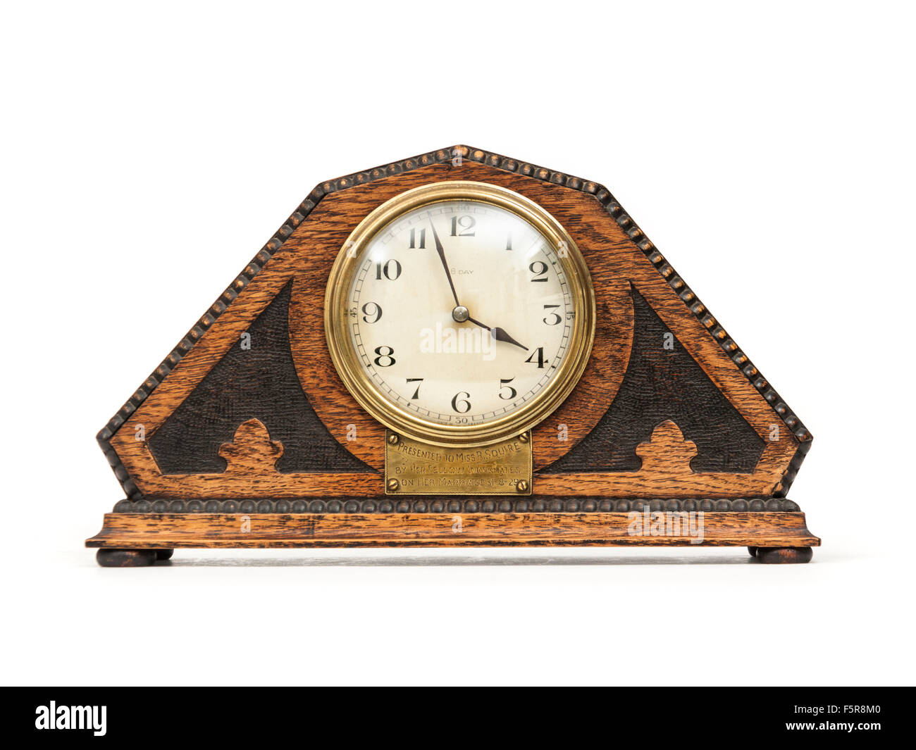 Antique (1929) Art Deco wooden mantel clock with French mechanism. Stock Photo