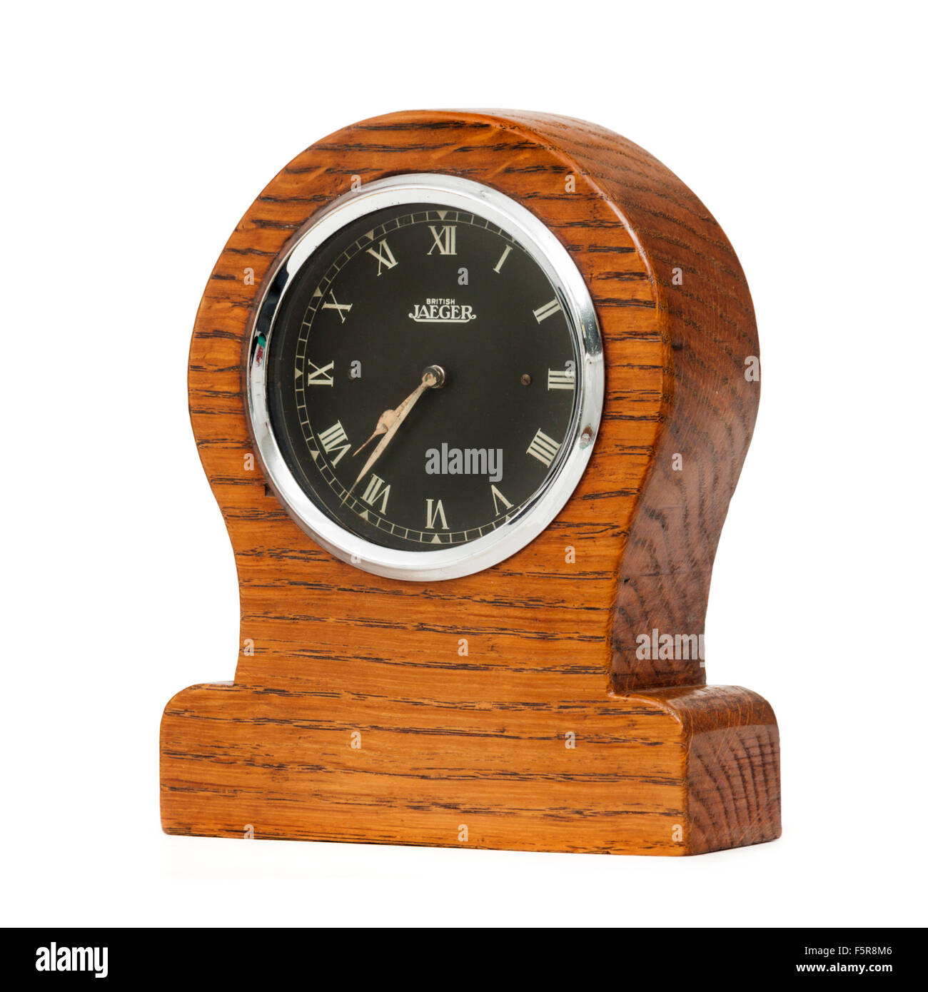 Vintage 1920's British Jaeger 8-day mechanical car dashboard clock (side-illuminated FAZ model), mounted in a custom wooden case Stock Photo