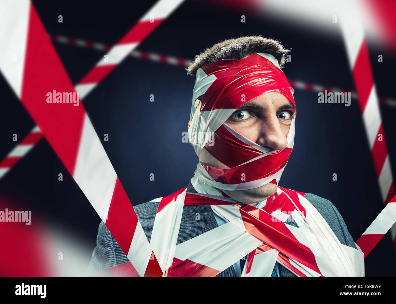 Scared man with stripped duct tape over body Stock Photo Alamy
