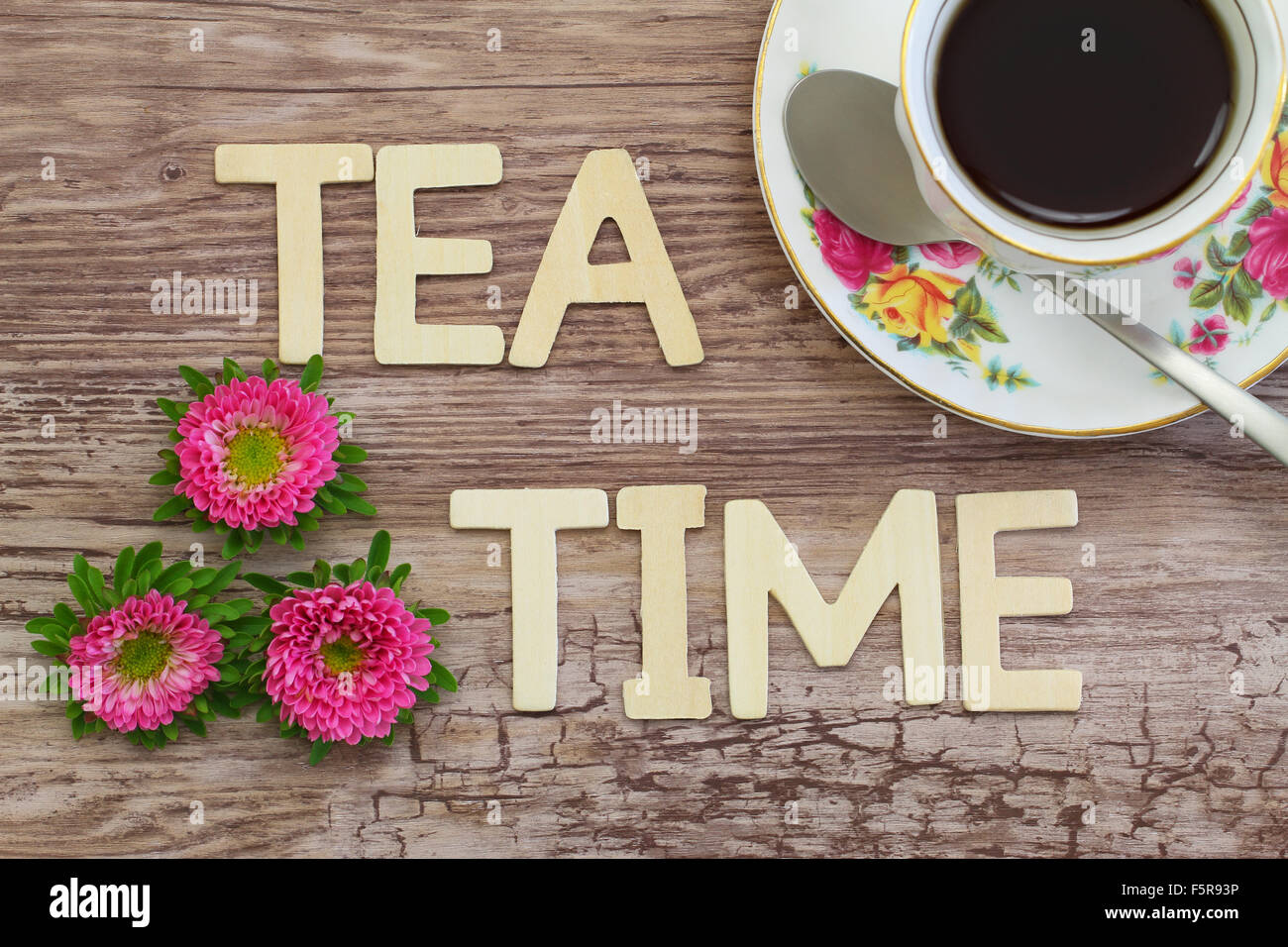 Tea time written with wooden letters on rustic surface Stock Photo