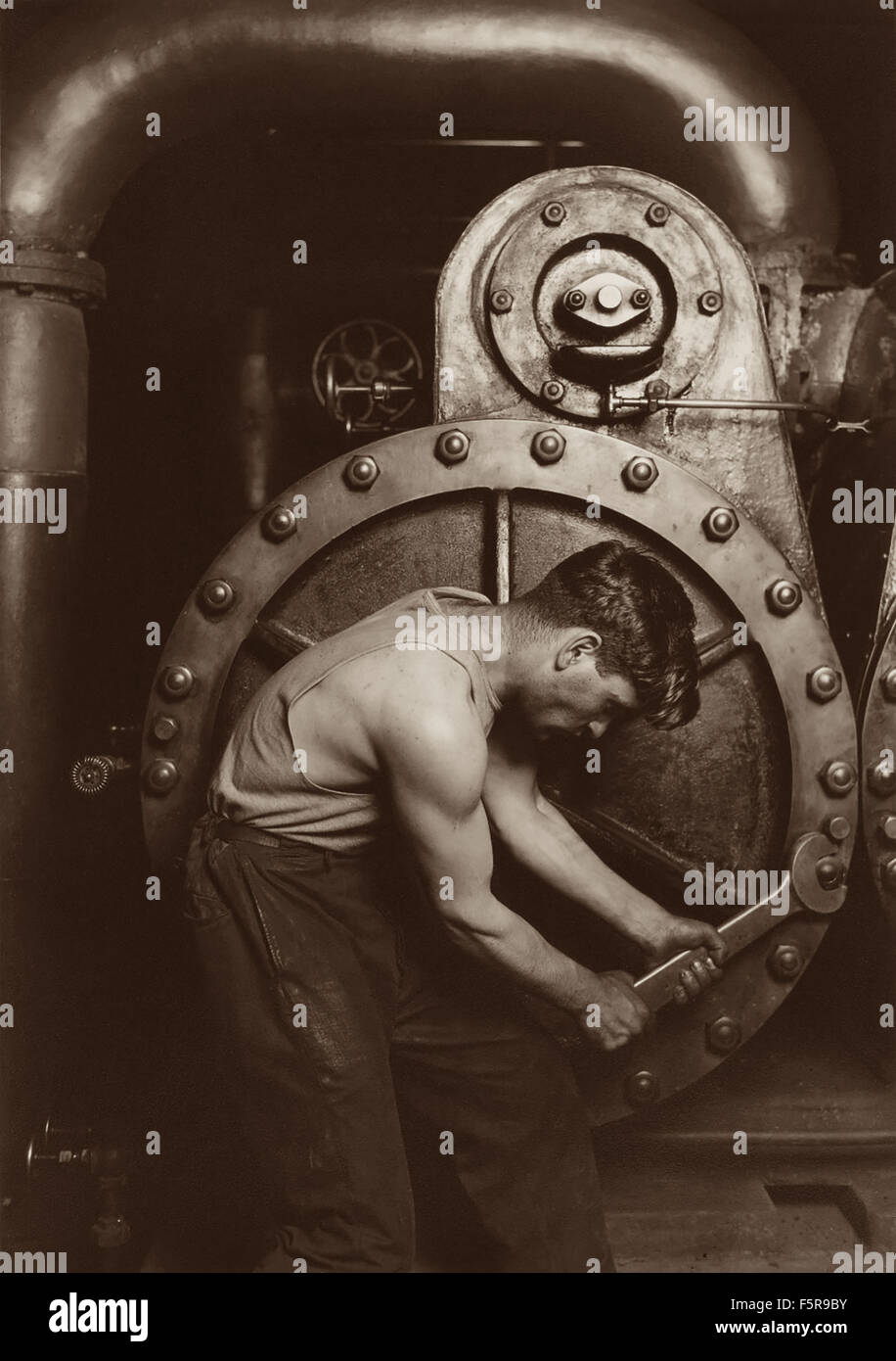 1920 photograph by Lewis Wickes Hine (American, 1874-1940) called Power House Mechanic. Stock Photo