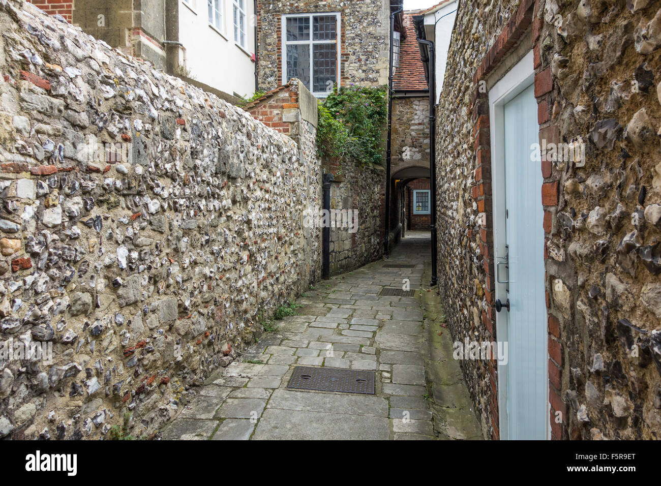 Vicars close a small passageway with flint walls leading into the