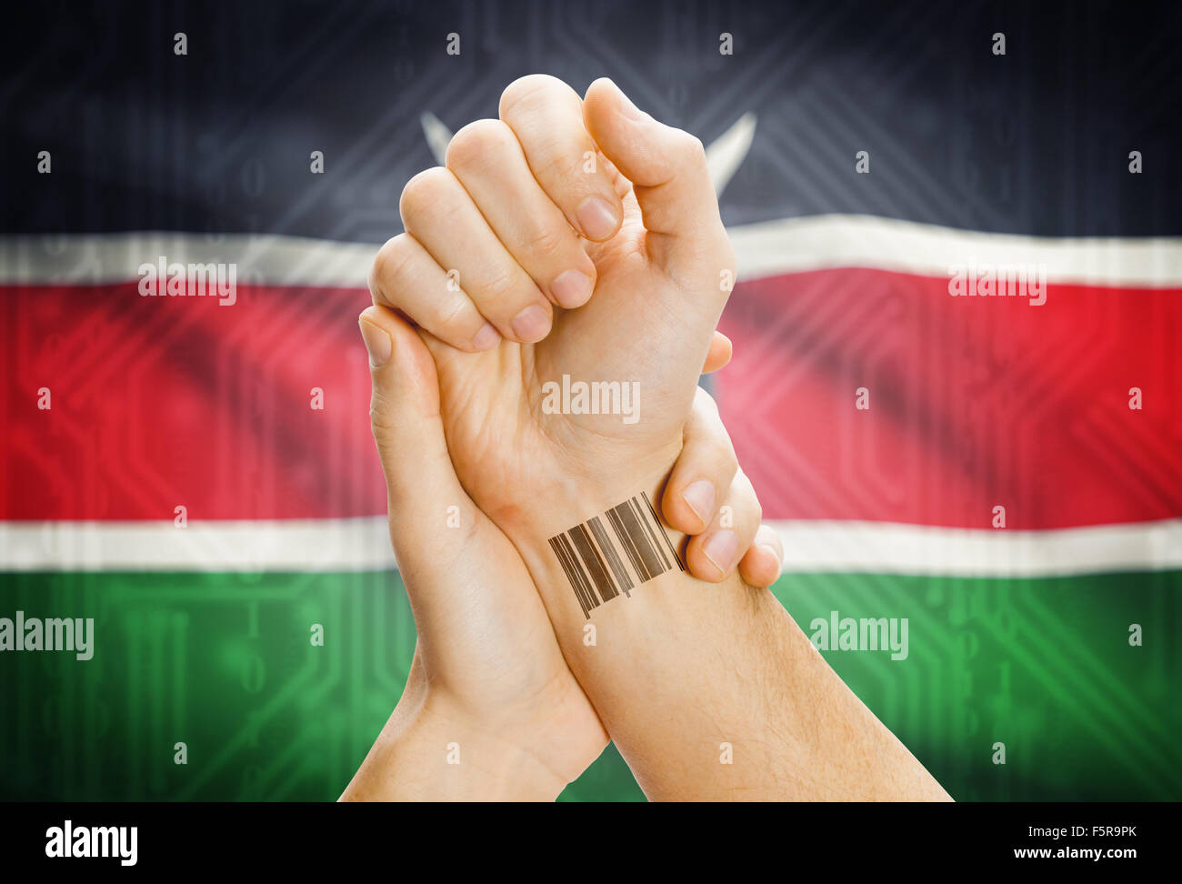 Barcode ID number on wrist of a human and national flag on background - Kenya Stock Photo