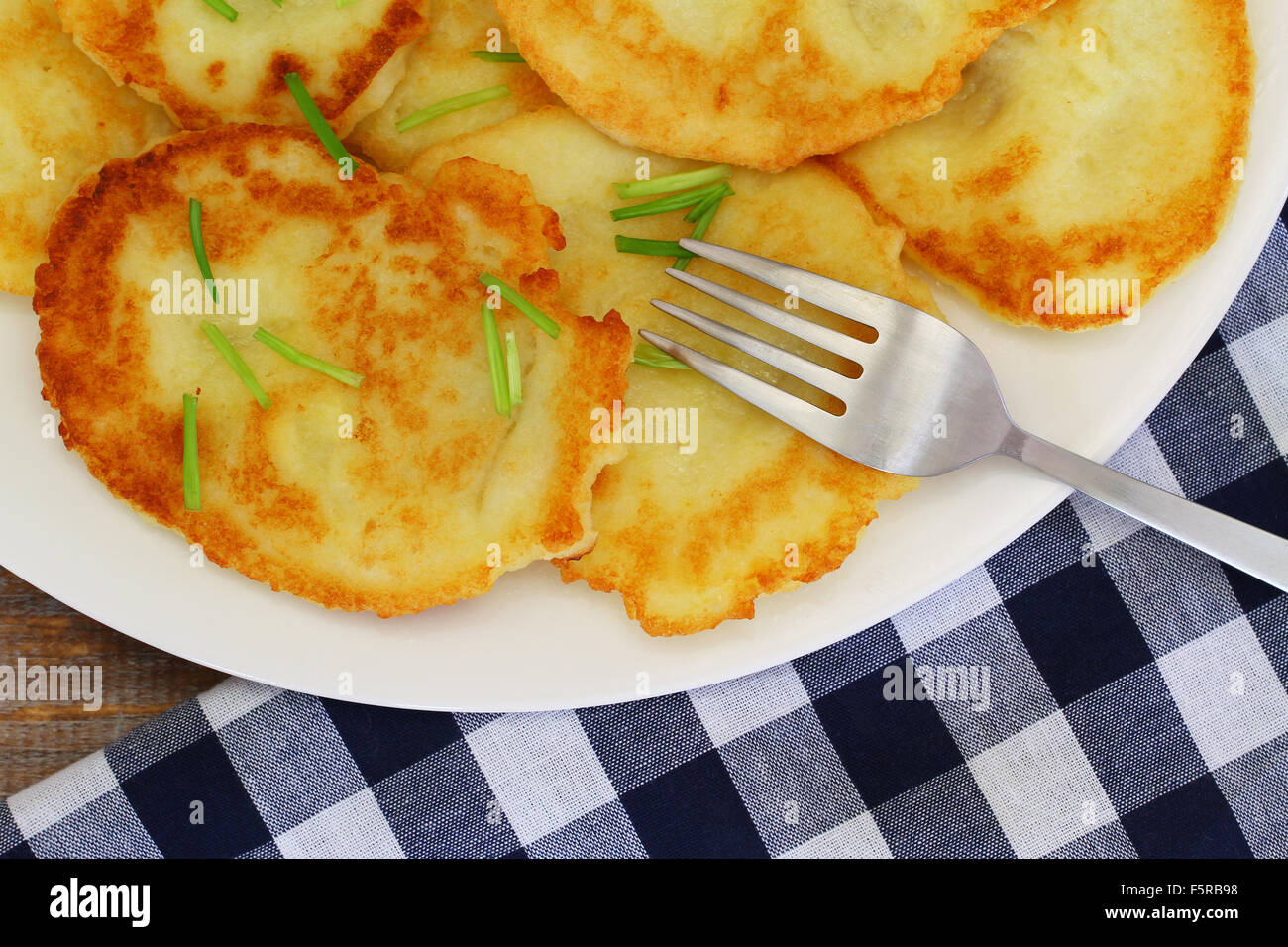 Delicious potato fritters on white plate, closeup Stock Photo