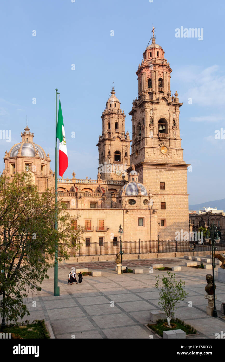 Nuns walk across the plaza of the cathedral of Morelia, Mexico. Stock Photo
