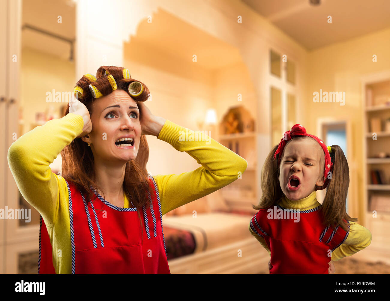 Angry little girl bawling at her mother at home Stock Photo