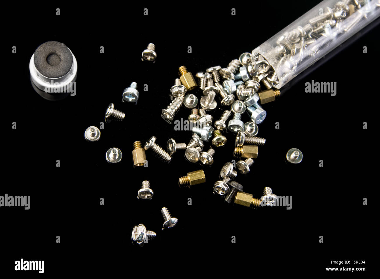 Screws and capsule isolated on black Stock Photo