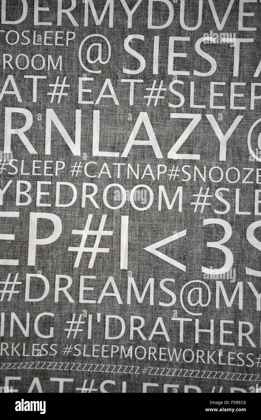 Words and symbols on a black duvet cover hanging from a washing line. Stock Photo