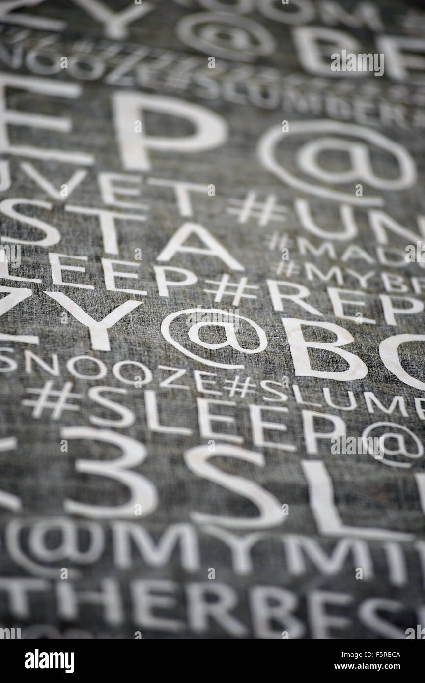 Words and symbols on a black duvet cover hanging from a washing line. Stock Photo