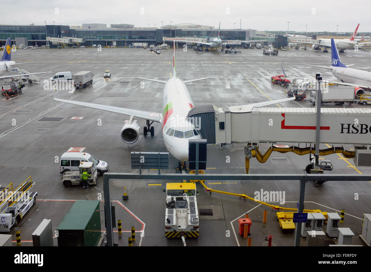 A small plane is loaded at Heathrow Airport in the UK. Stock Photo