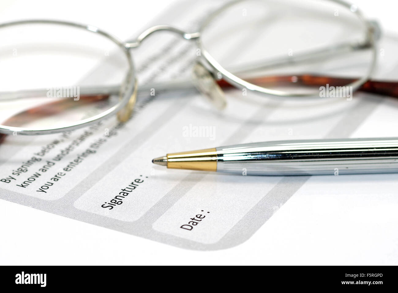 signature field on document with pen and glasses Stock Photo