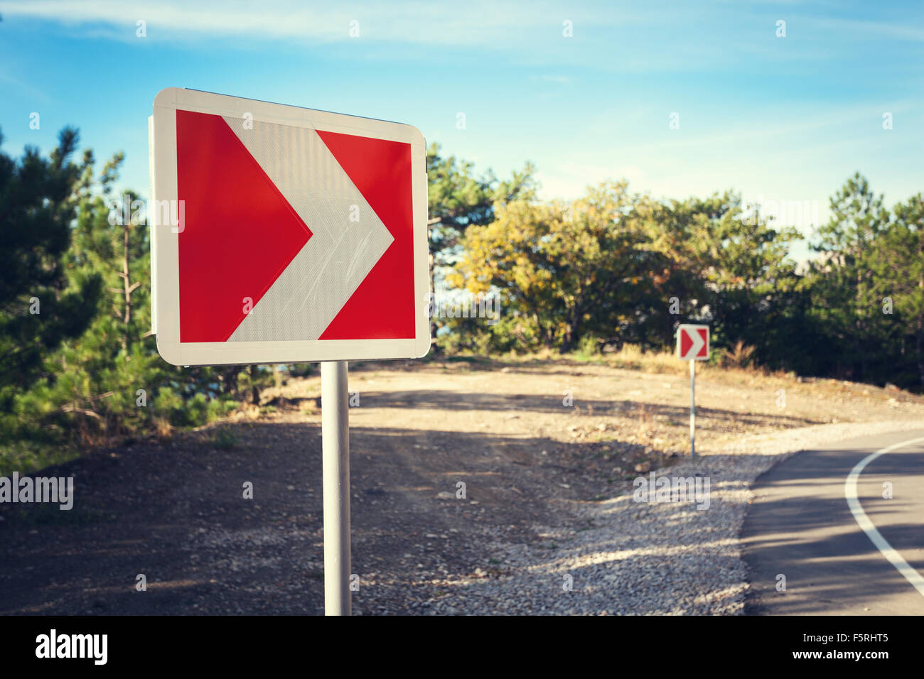 Asphalt road in autumn forest at sunrise. Crimean mountains. Stock Photo