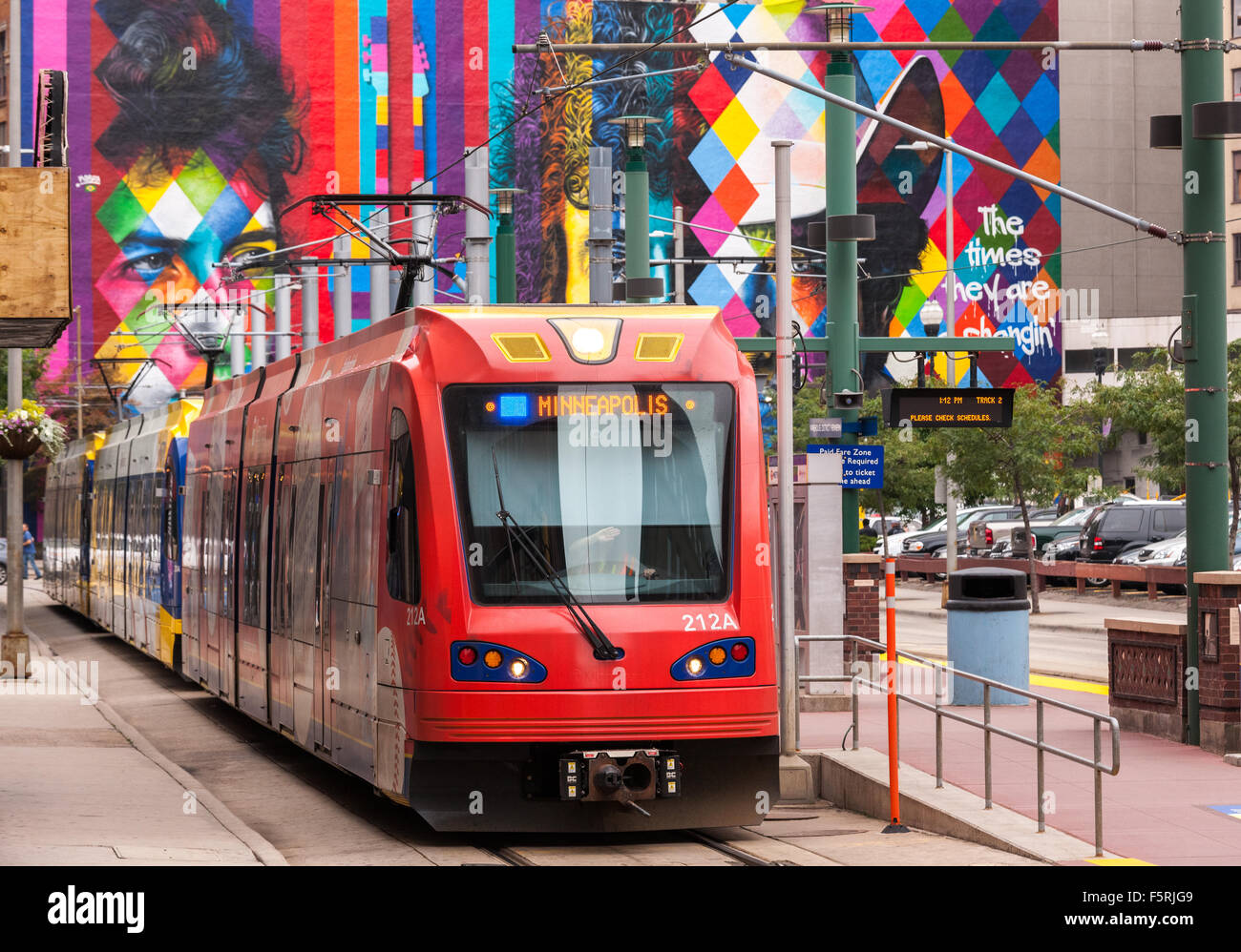 Downtown Minneapolis. Metro Transit Blue Line Hiawatha Light Rail at Warehouse Hennepin stop. Bob Dylan Mural in the background. Stock Photo