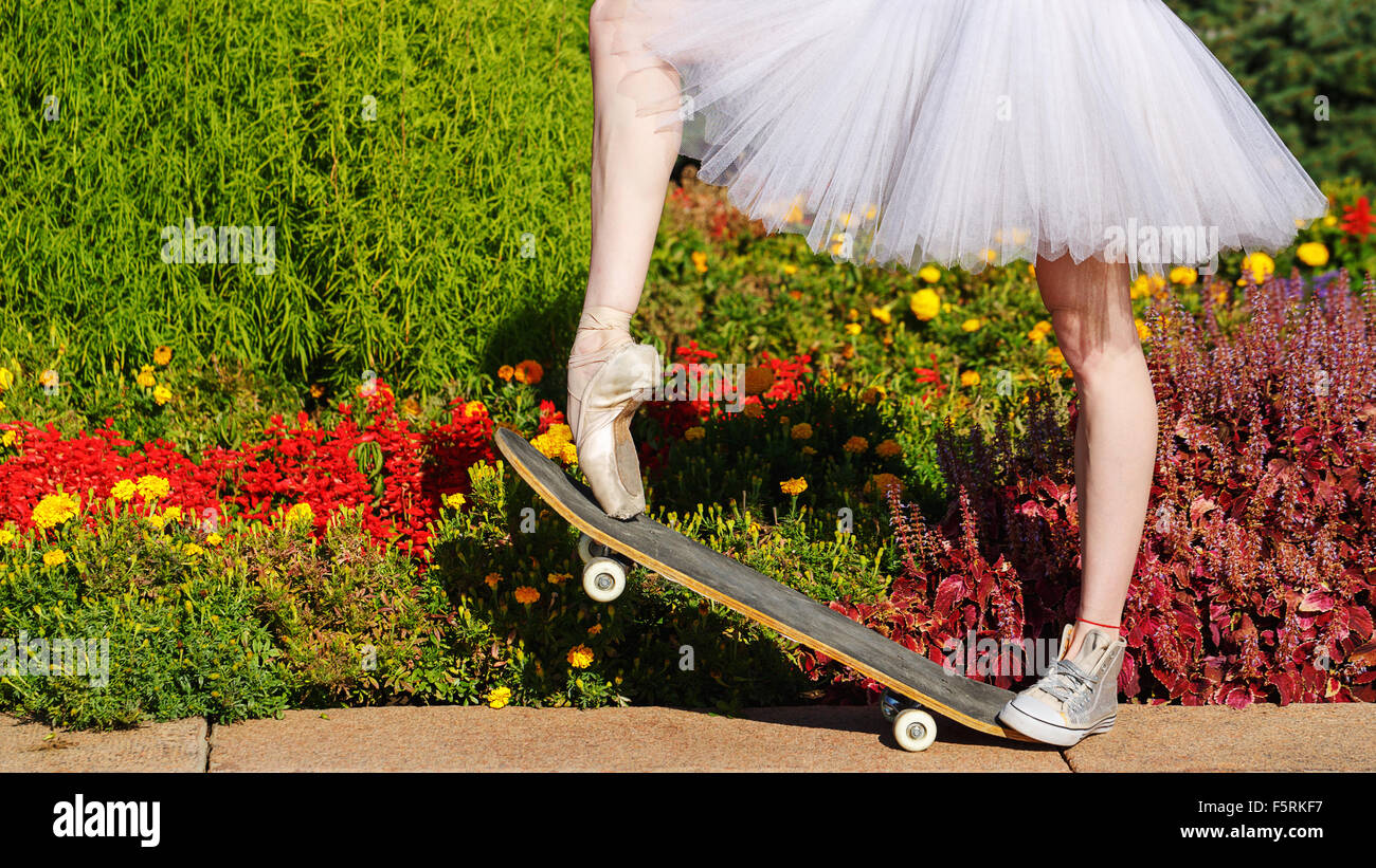 Legs of a ballerina on a skateboard. Feet shod in sneakers and pointes.  Modern fashion. Photo closeup Stock Photo - Alamy