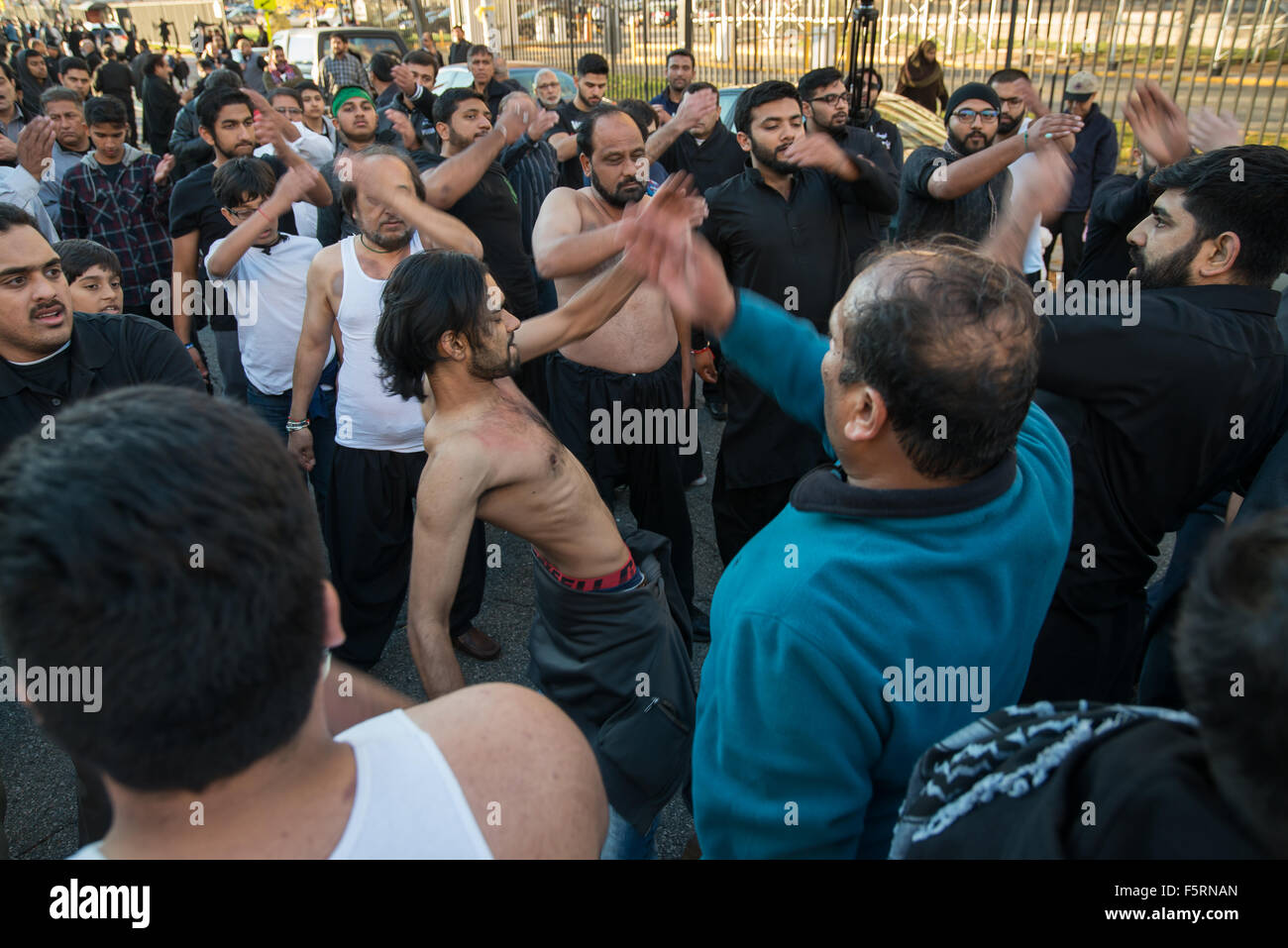 Jersey City, United States. 08th Nov, 2015. Muslim men beat their chests performing matam (latmya) in lamentation of the martyrdom of Hussein ibn Ali. Shia Muslims gathered in Jersey City to commemorate the martyrdom of Hussein ibn Ali, the grandson of the Prophet Muhammad, by participating in a Muharram procession from Exchange Place to City Hall on Montgomery Street. Credit:  Albin Lohr-Jones/Pacific Press/Alamy Live News Stock Photo