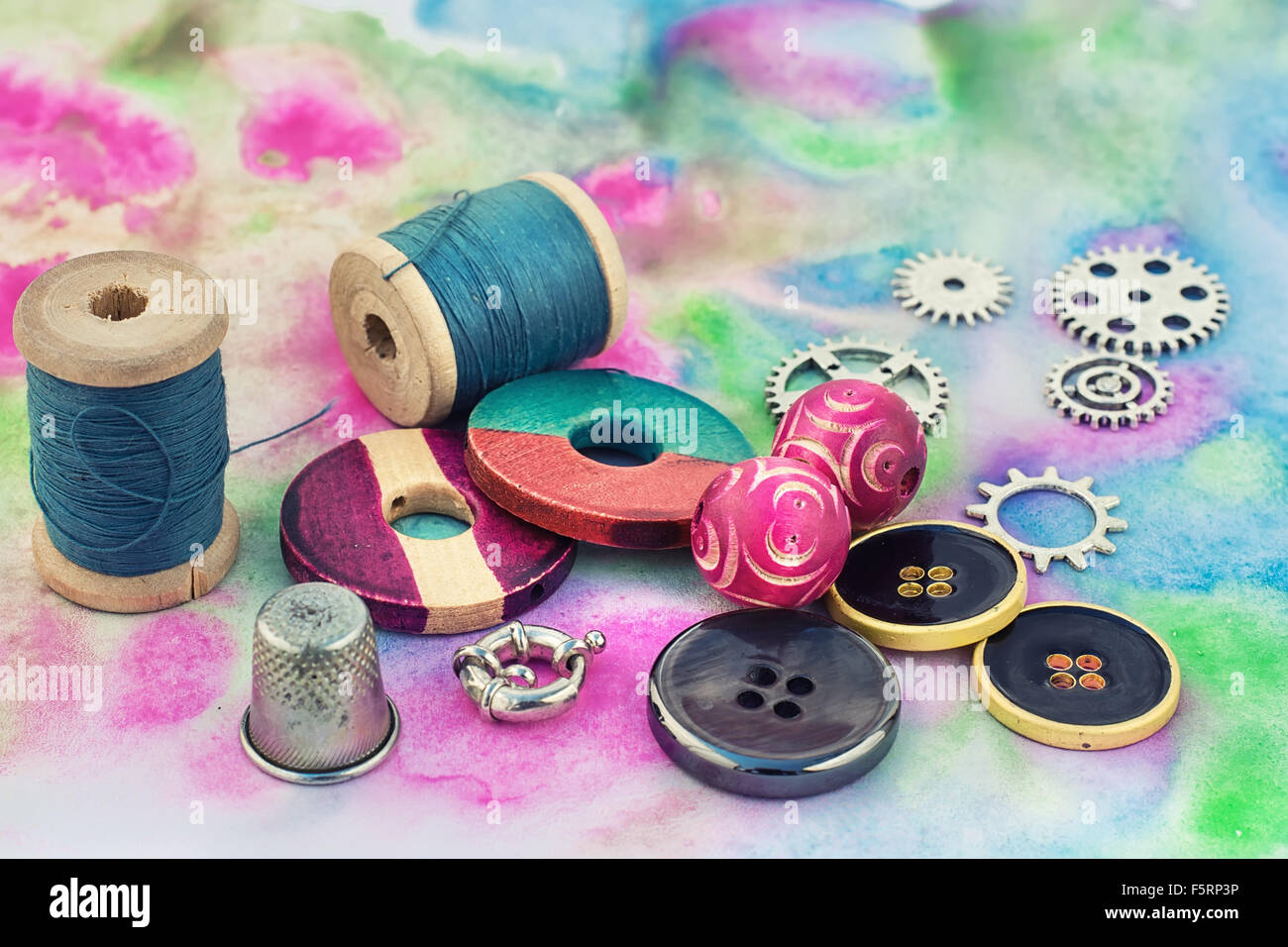 spool of thread with beads and accessories for needlework on bright background Stock Photo Alamy