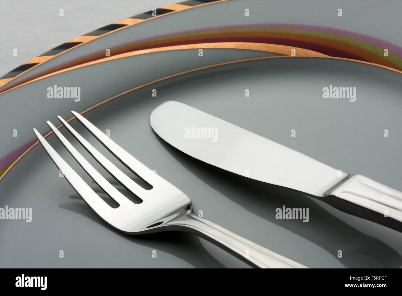 Dinner set. Fork and knife on plate Stock Photo - Alamy