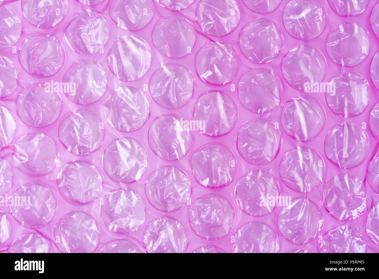 Pink plastic protective bubble wrap background Stock Photo - Alamy