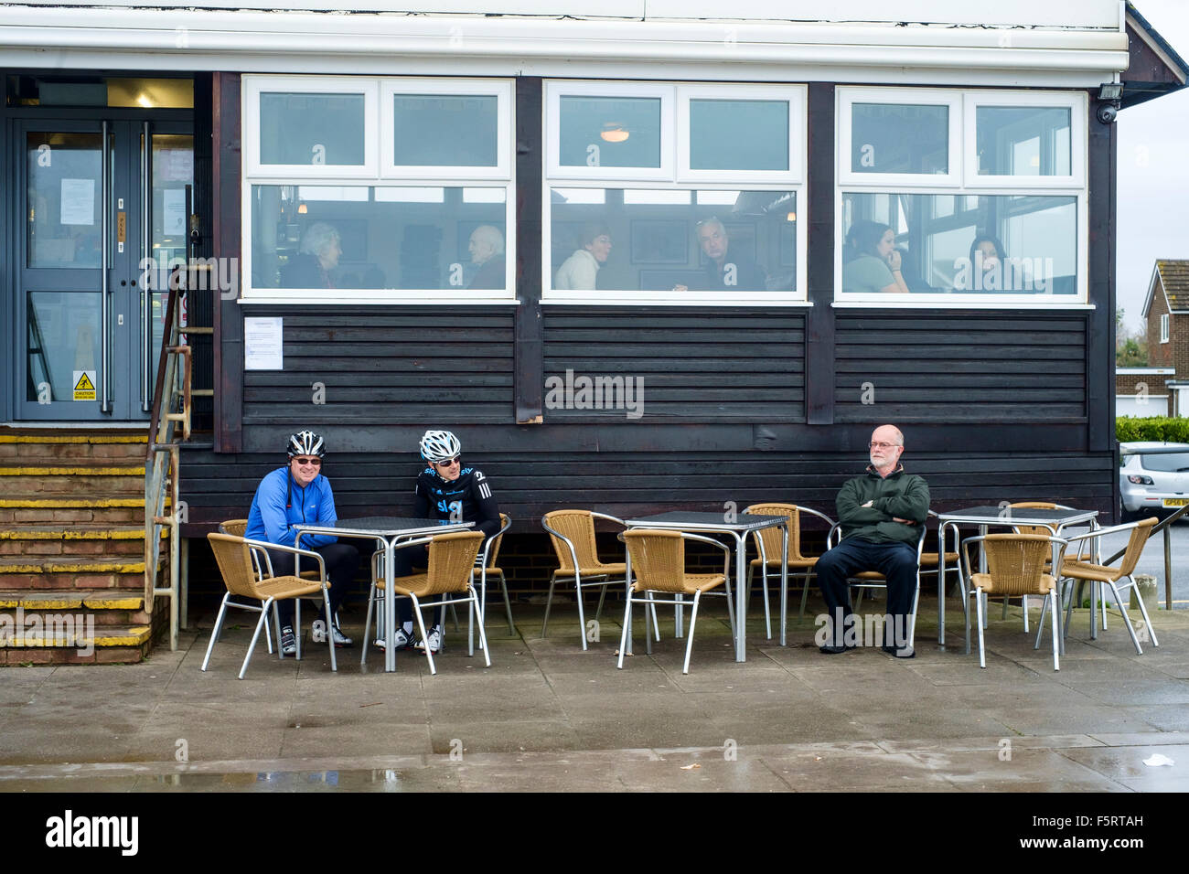 Walkers and cyclists relax at Sea Lane Café, Goring on a wintry Sunday