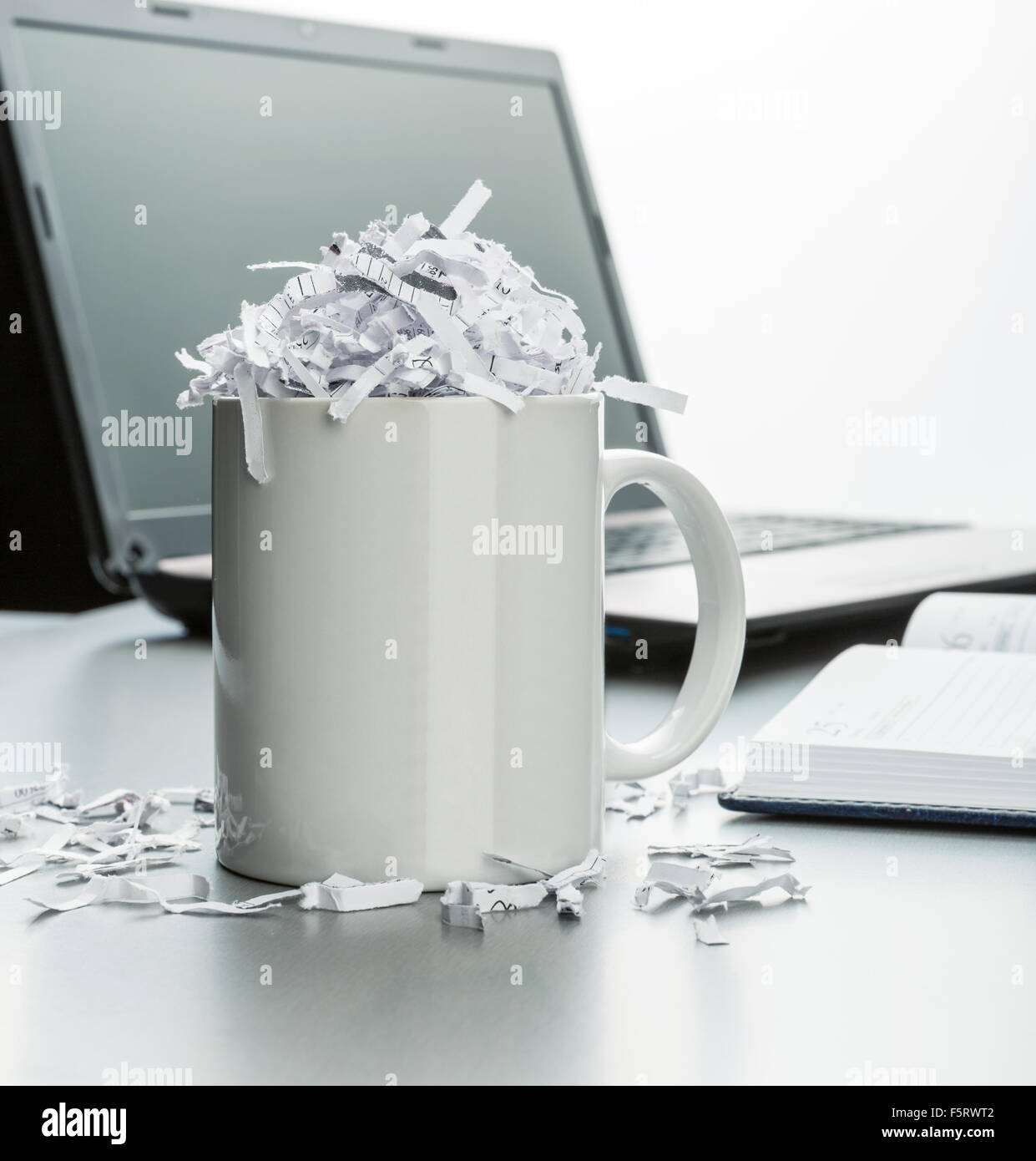 White cup full of shredded paper Stock Photo - Alamy