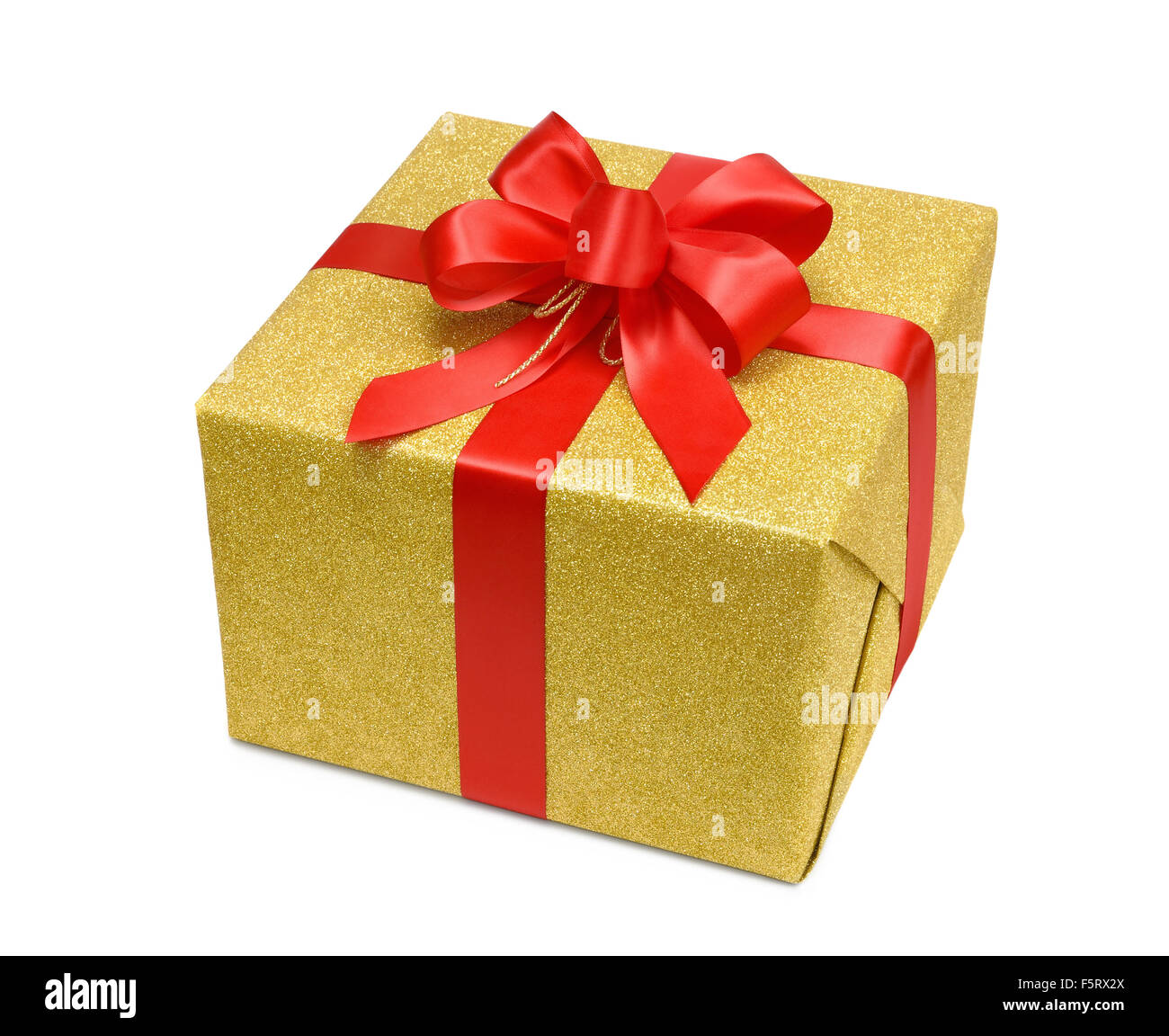 Glittering gold gift box on white background with a nice red bow Stock Photo