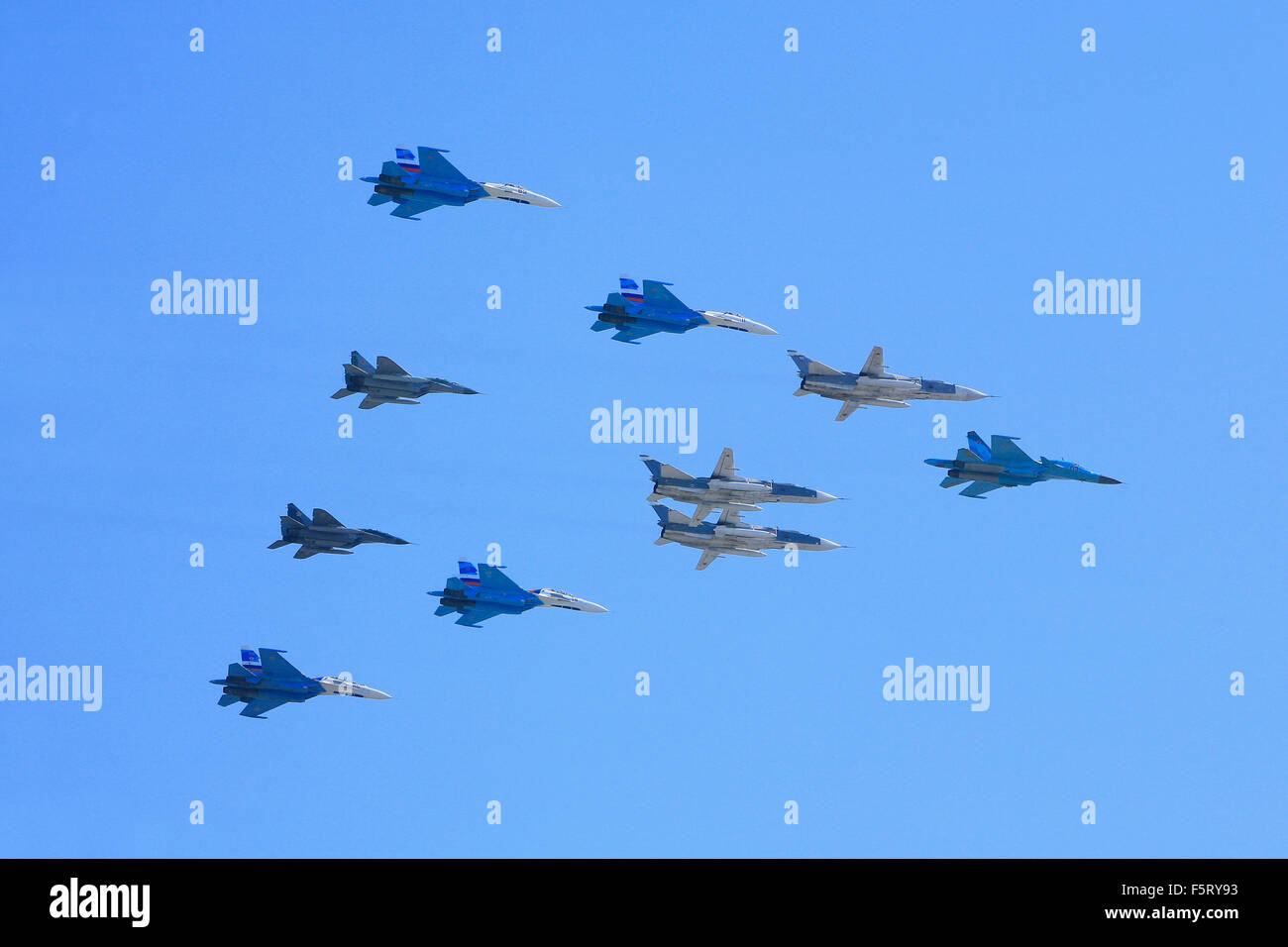 Russian Air Force fighters (Su-34, Su-24, Su-27 and MiG-29) flying in formation during the Victory Day Parade in Moscow, Russia Stock Photo