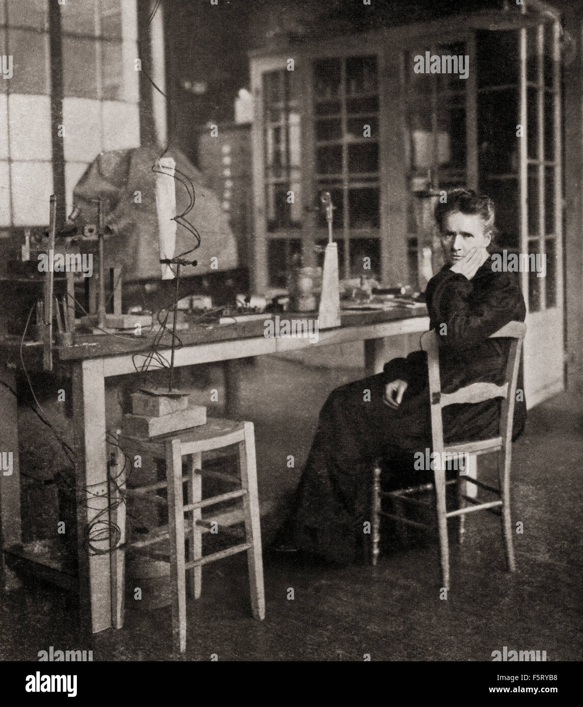 Marie Skłodowska Curie, 1867 - 1934.  Polish and naturalized-French physicist and chemist who conducted pioneering research on radioactivity. Here seen in her laboratory. Stock Photo