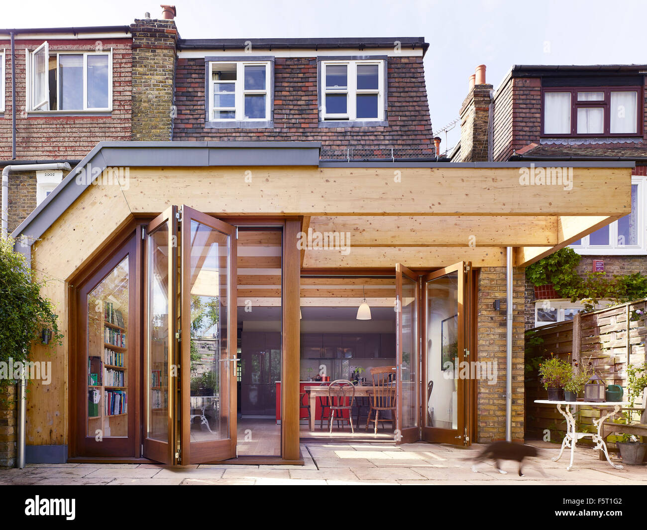 Timber frame of extension with concertina doors viewed from garden ... Timber frame of extension with concertina doors viewed from garden ...