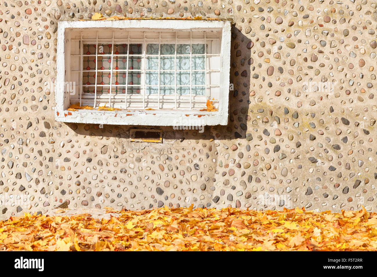 Old window on concrete stony wall with autumnal leaves Stock Photo - Alamy