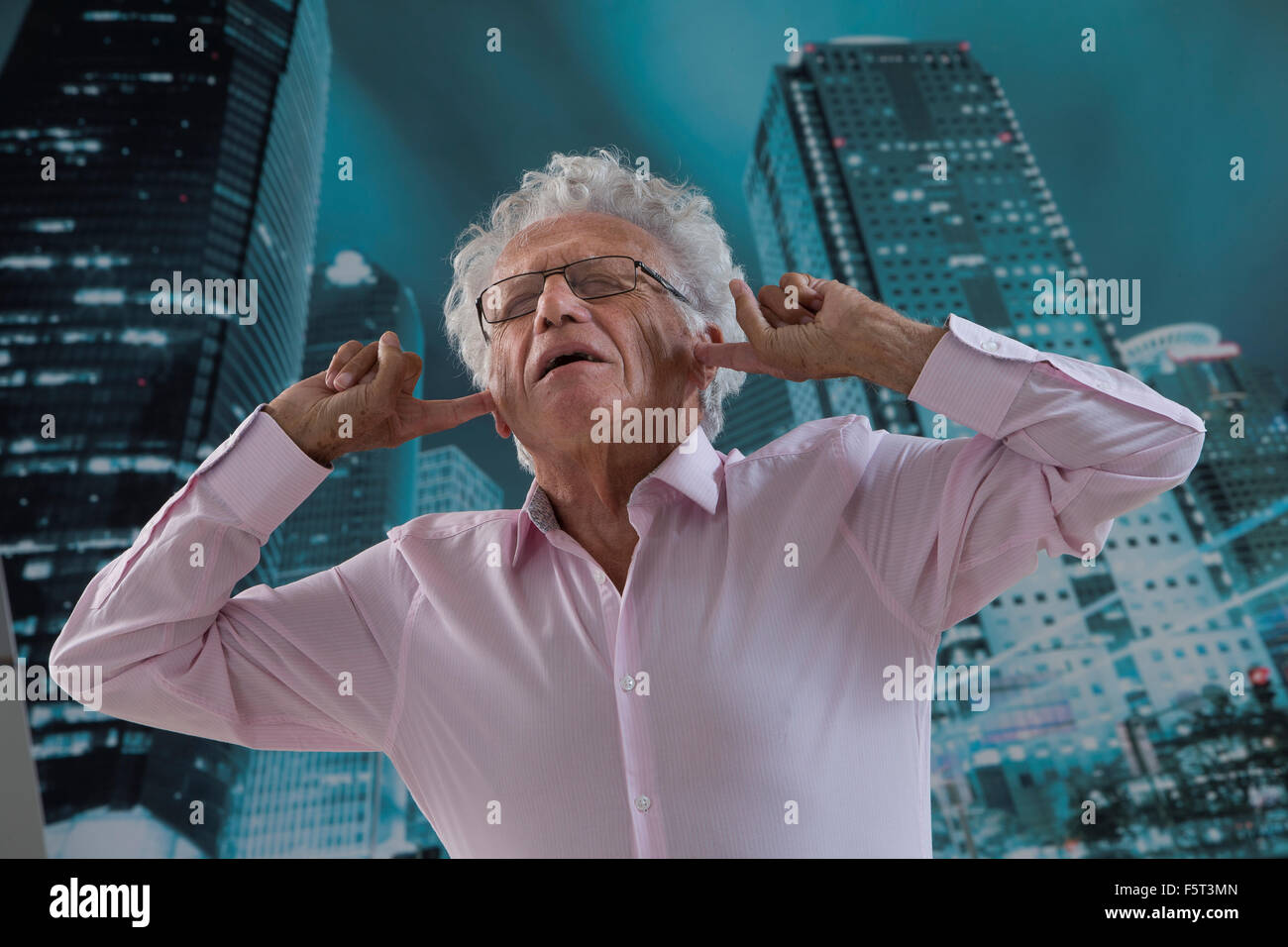 Businessman with his fingers in ears Stock Photo