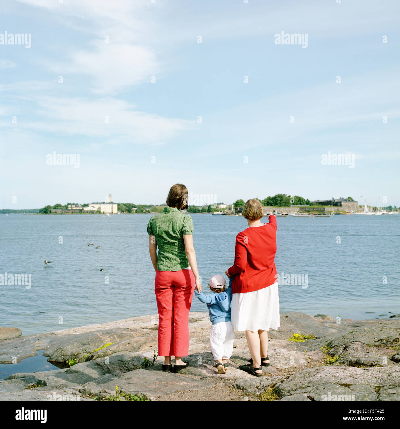 Finland, Helsinki, Uusimaa, Rear view of mother, daughter (2-3) and grandmother Stock Photo