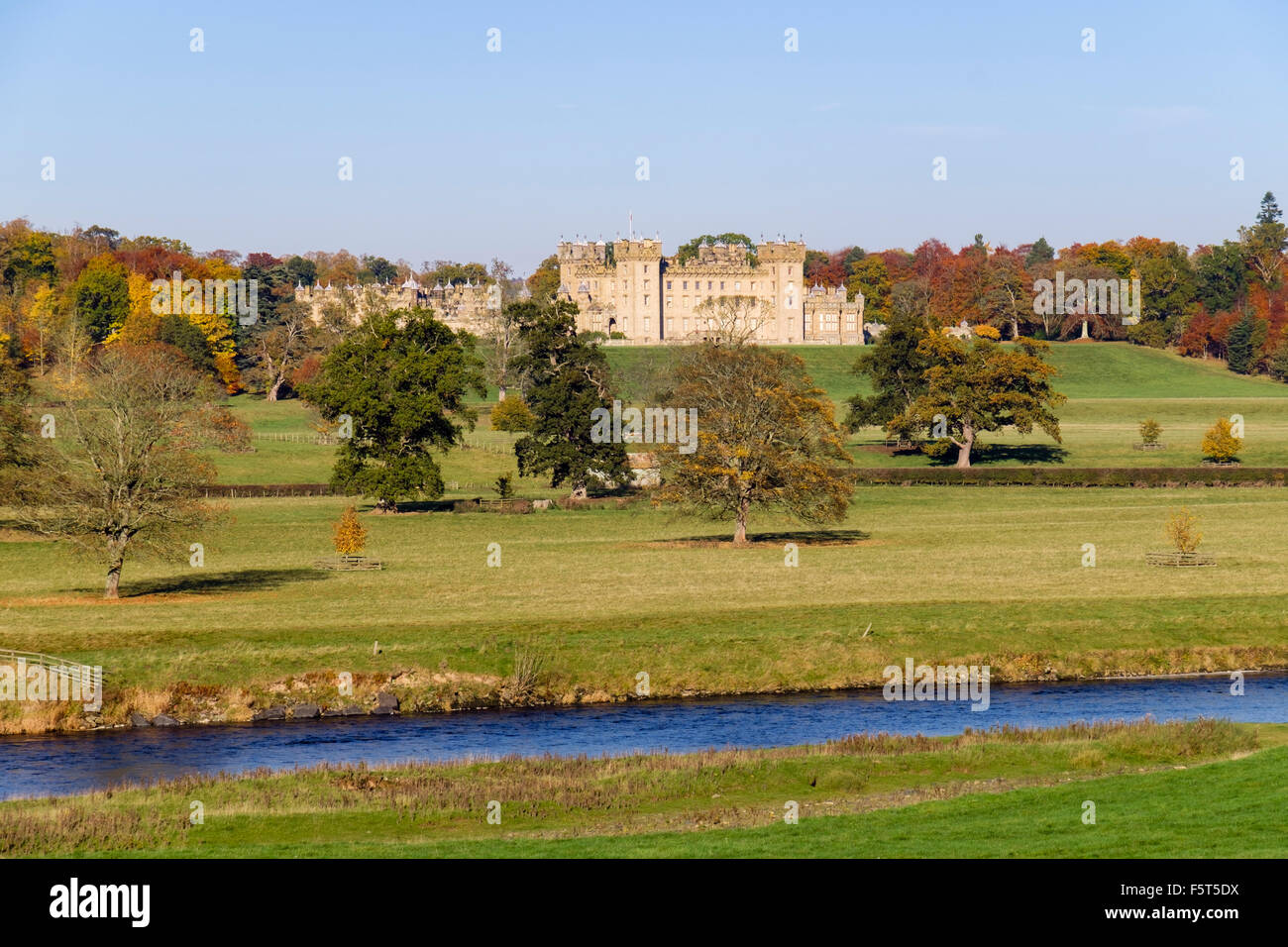 Floors Castle and grounds in autumn from across River Tweed. Kelso Berwickshire Scottish Borders Scotland UK Britain Stock Photo