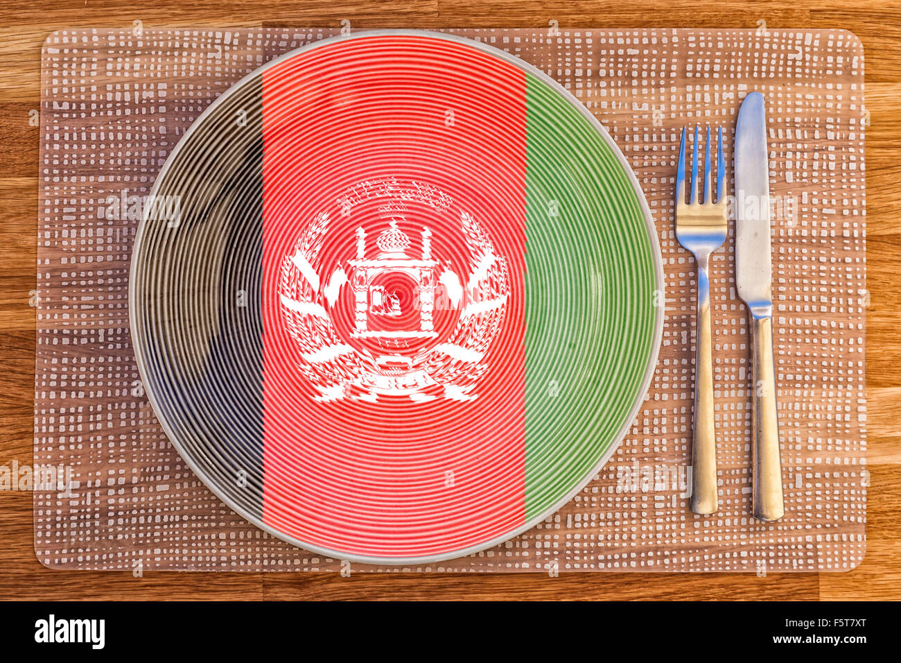 Dinner plate with the flag of Afghanistan on it for your international food and drink concepts. Stock Photo