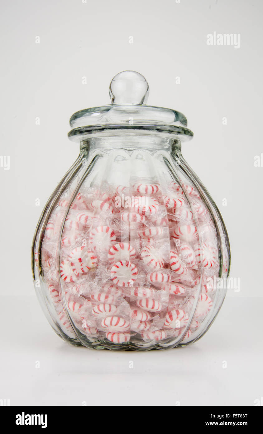 A jar of peppermint candies against a white background Stock Photo - Alamy