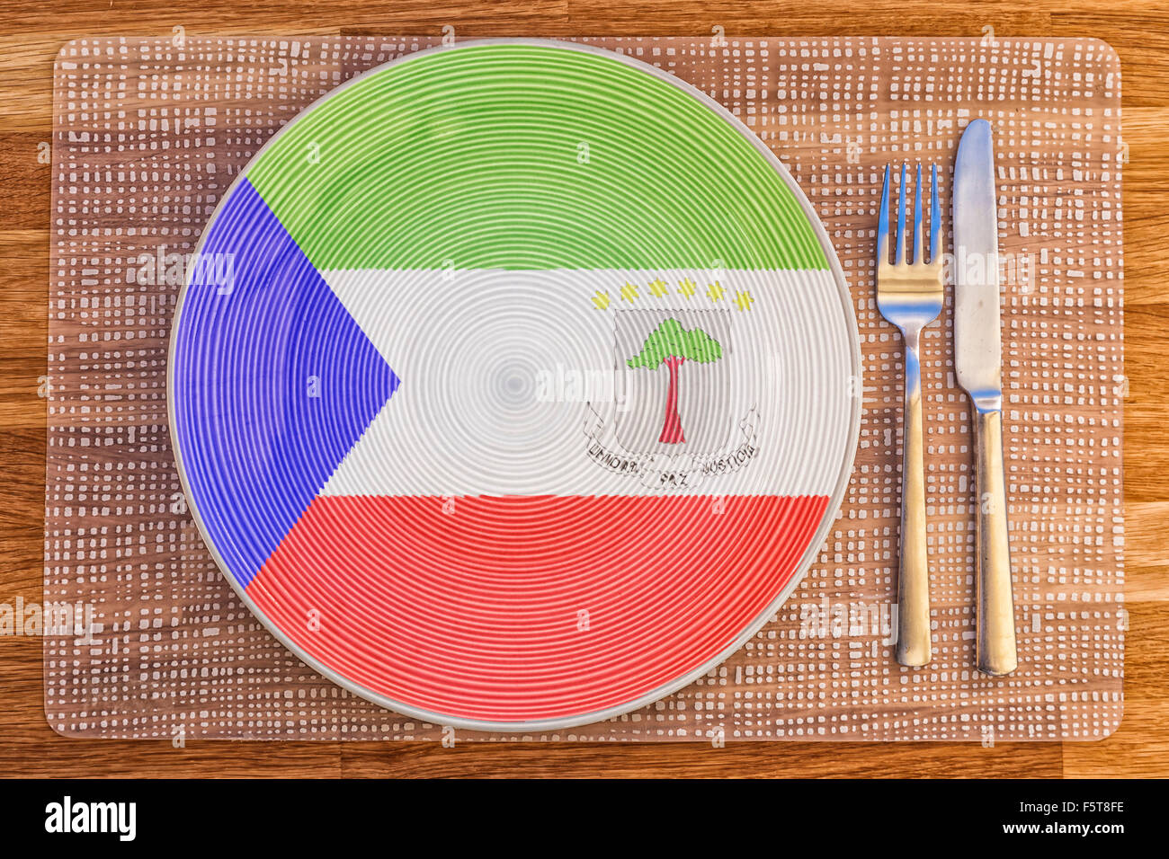 Dinner plate with the flag of Equatorial Guinea on it for your international food and drink concepts. Stock Photo