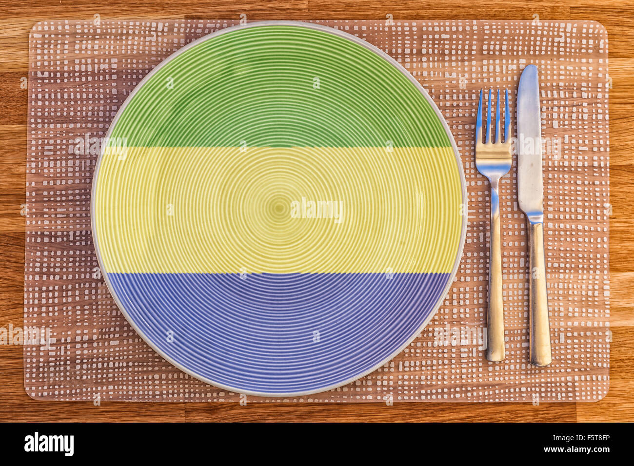 Dinner plate with the flag of Gabon on it for your international food and drink concepts. Stock Photo