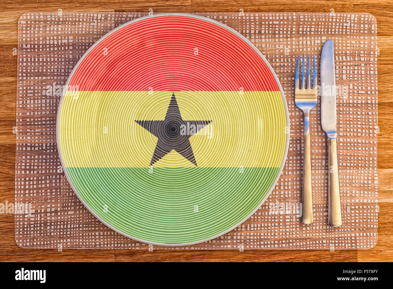Dinner plate with the flag of Ghana on it for your international food and drink concepts Stock