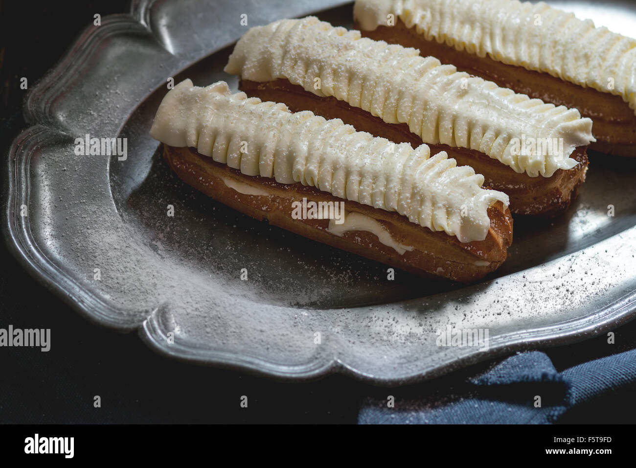 Eclairs in metal plate Stock Photo