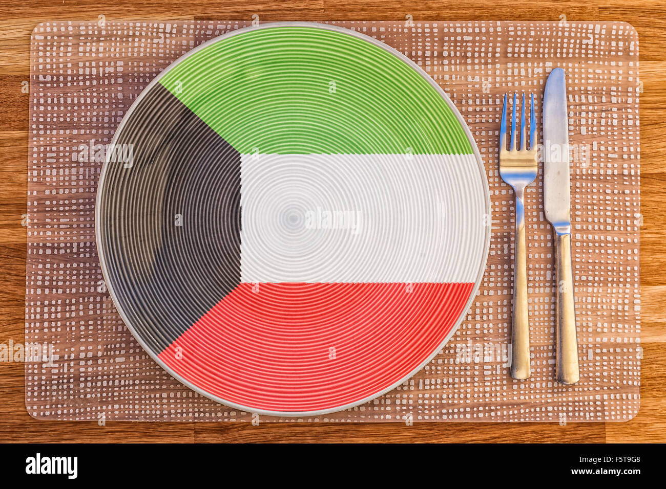 Dinner plate with the flag of Kuwait on it for your international food and drink concepts. Stock Photo
