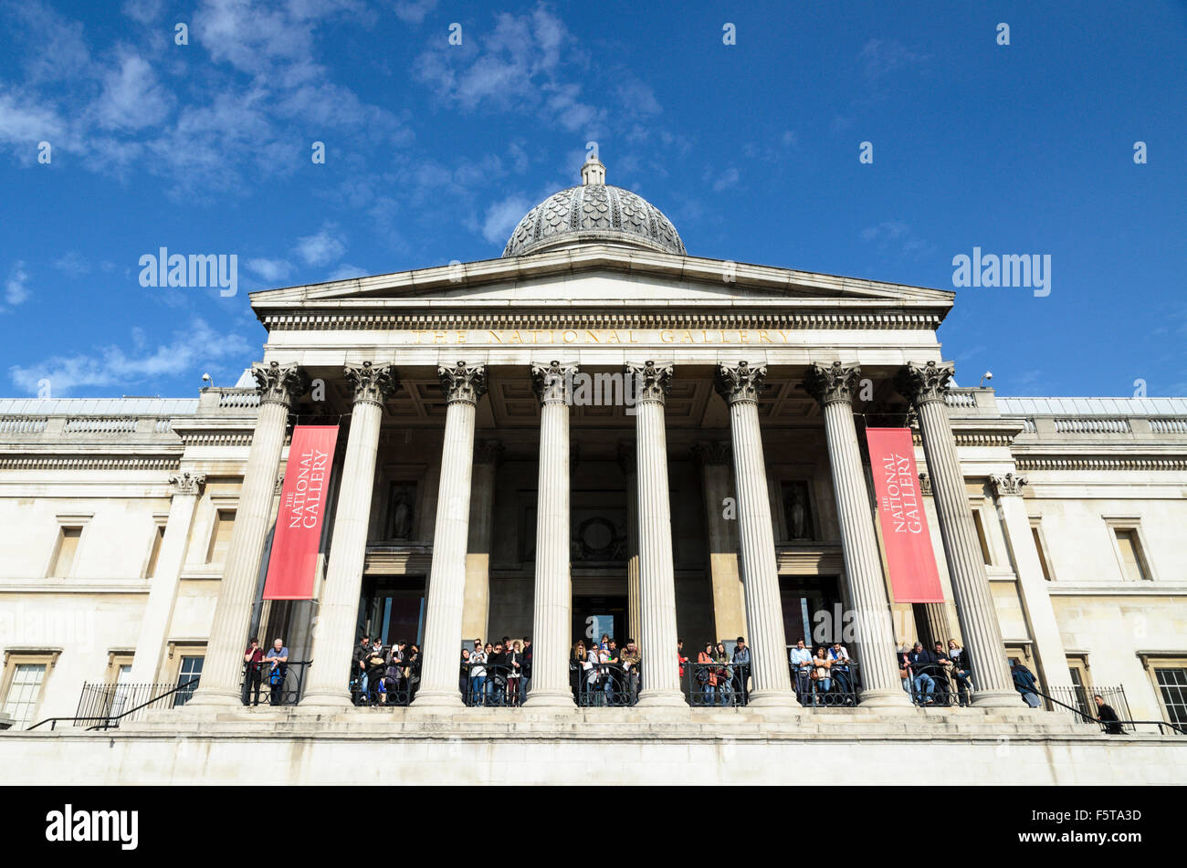 Tourists crowd the balcony of The National Gallery, Trafalgar Square, London, England, UK. Stock Photo