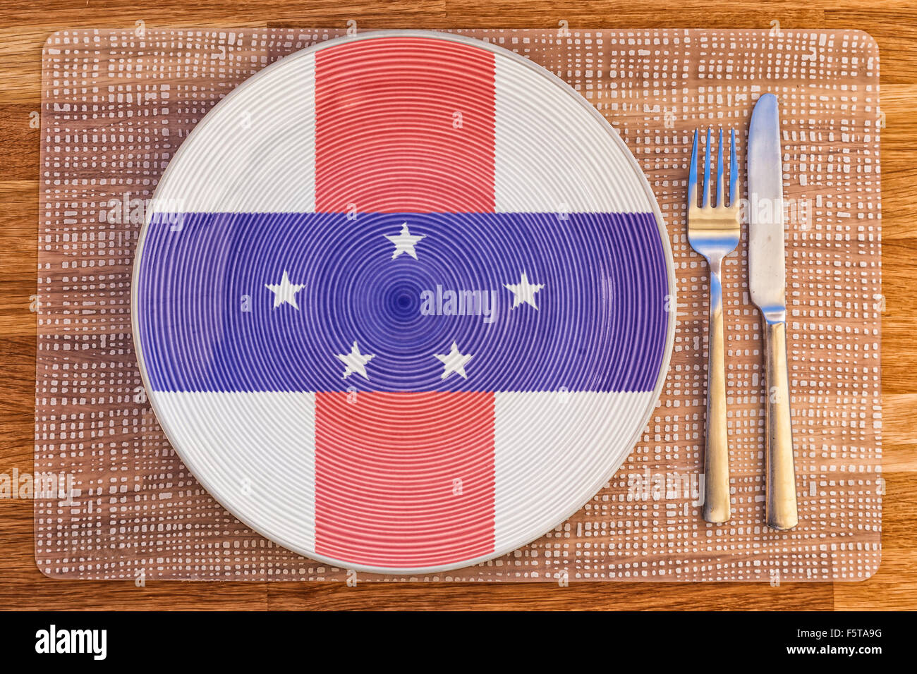 Dinner plate with the flag of Netherlands Antilles on it for your international food and drink concepts. Stock Photo