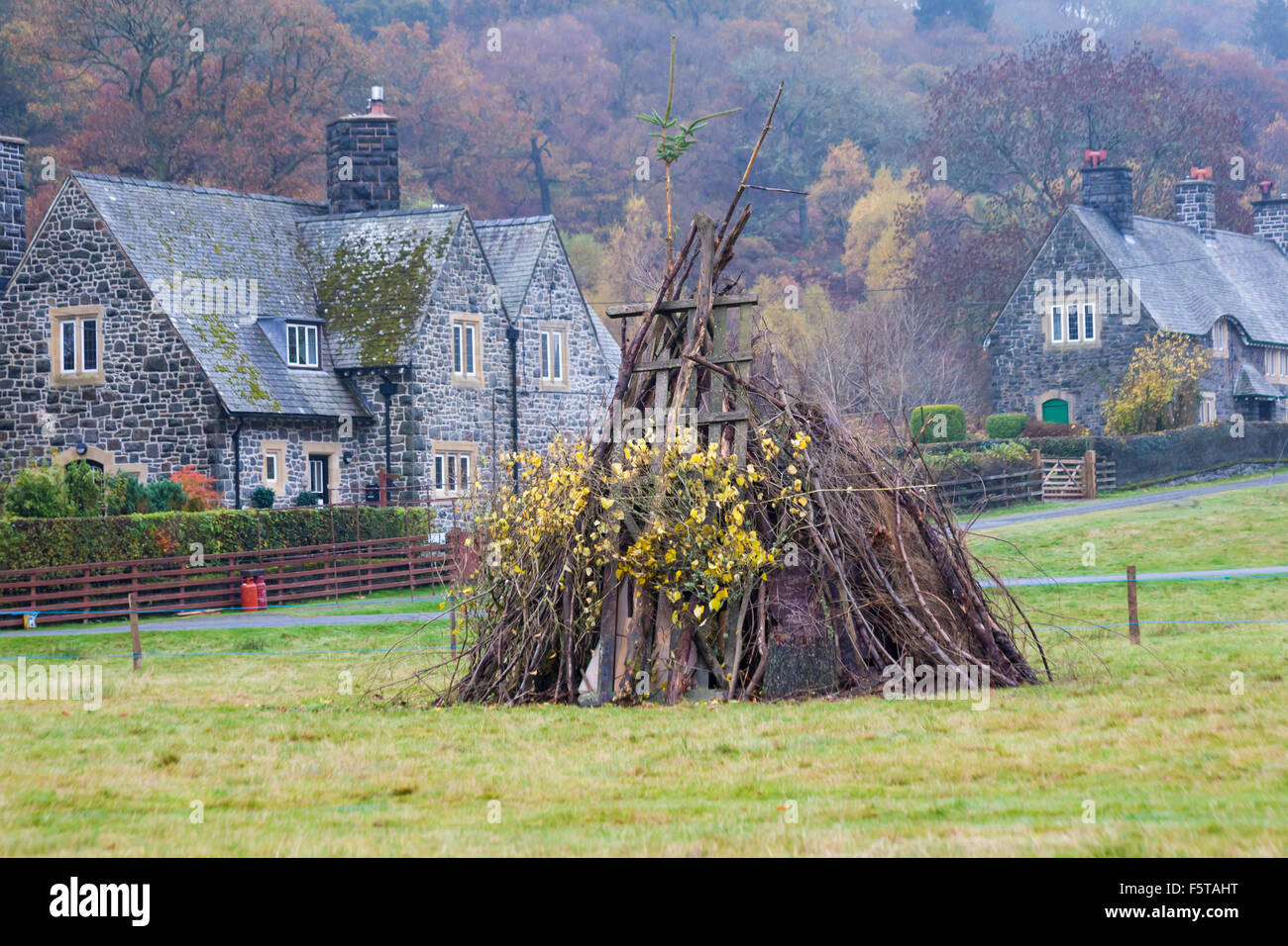 Houses in Autumn colours and bonfire ready for bonfire night at Elan village in Elan Valley, Powys, Mid Wales, UK in November Stock Photo