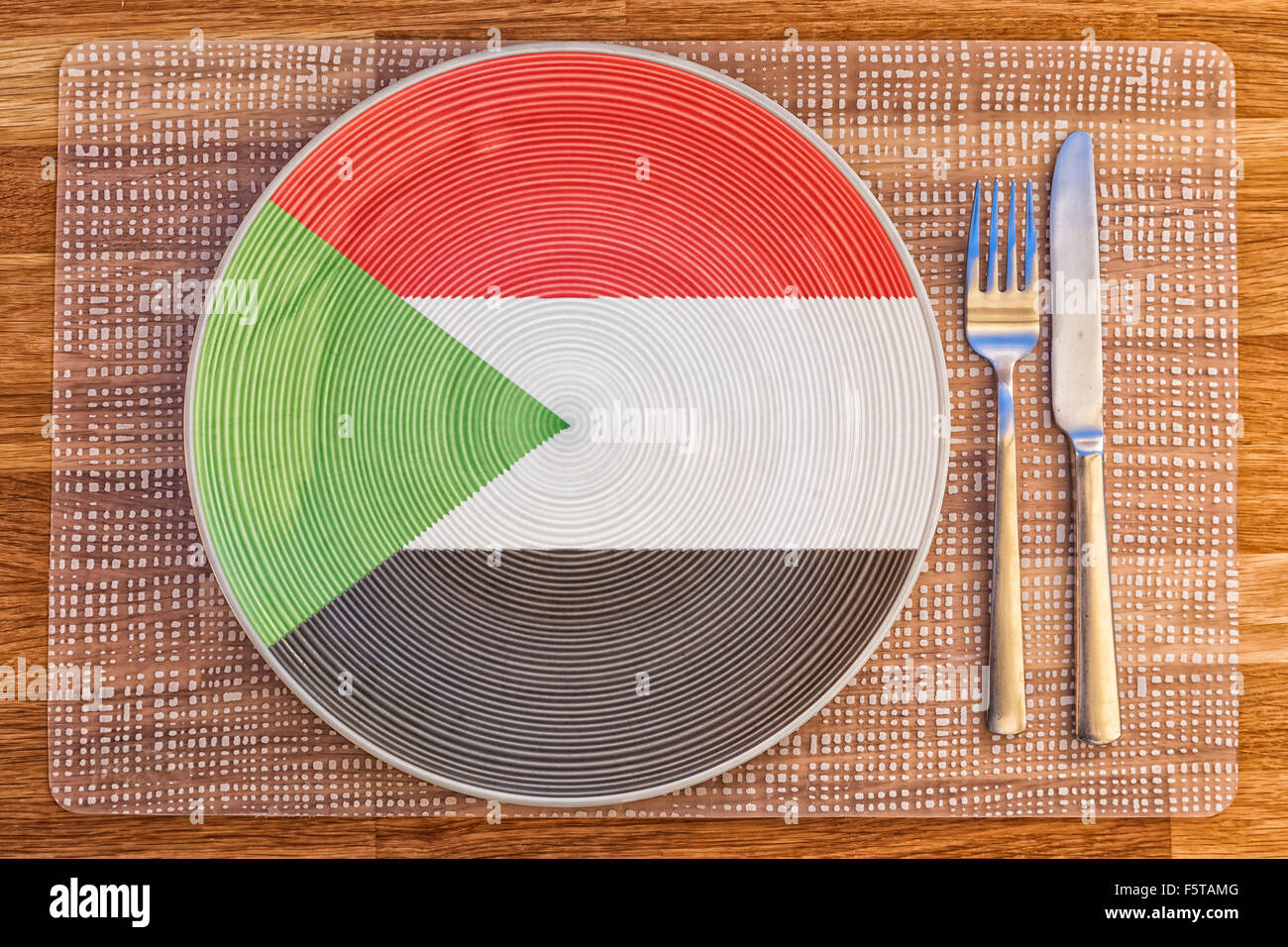 Dinner plate with the flag of Sudan on it for your international food and drink concepts. Stock Photo