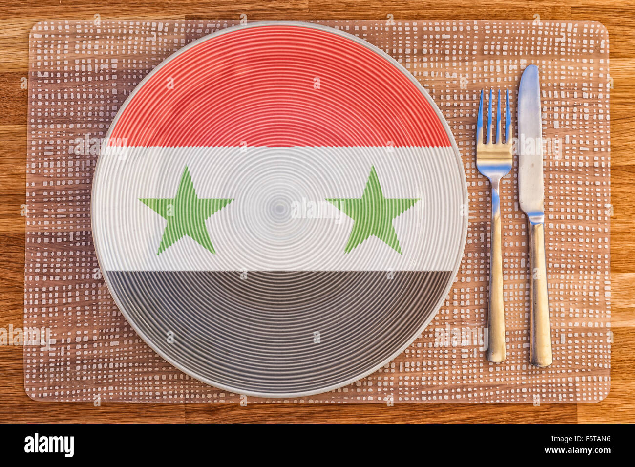 Dinner plate with the flag of Syria on it for your international food and drink concepts. Stock Photo