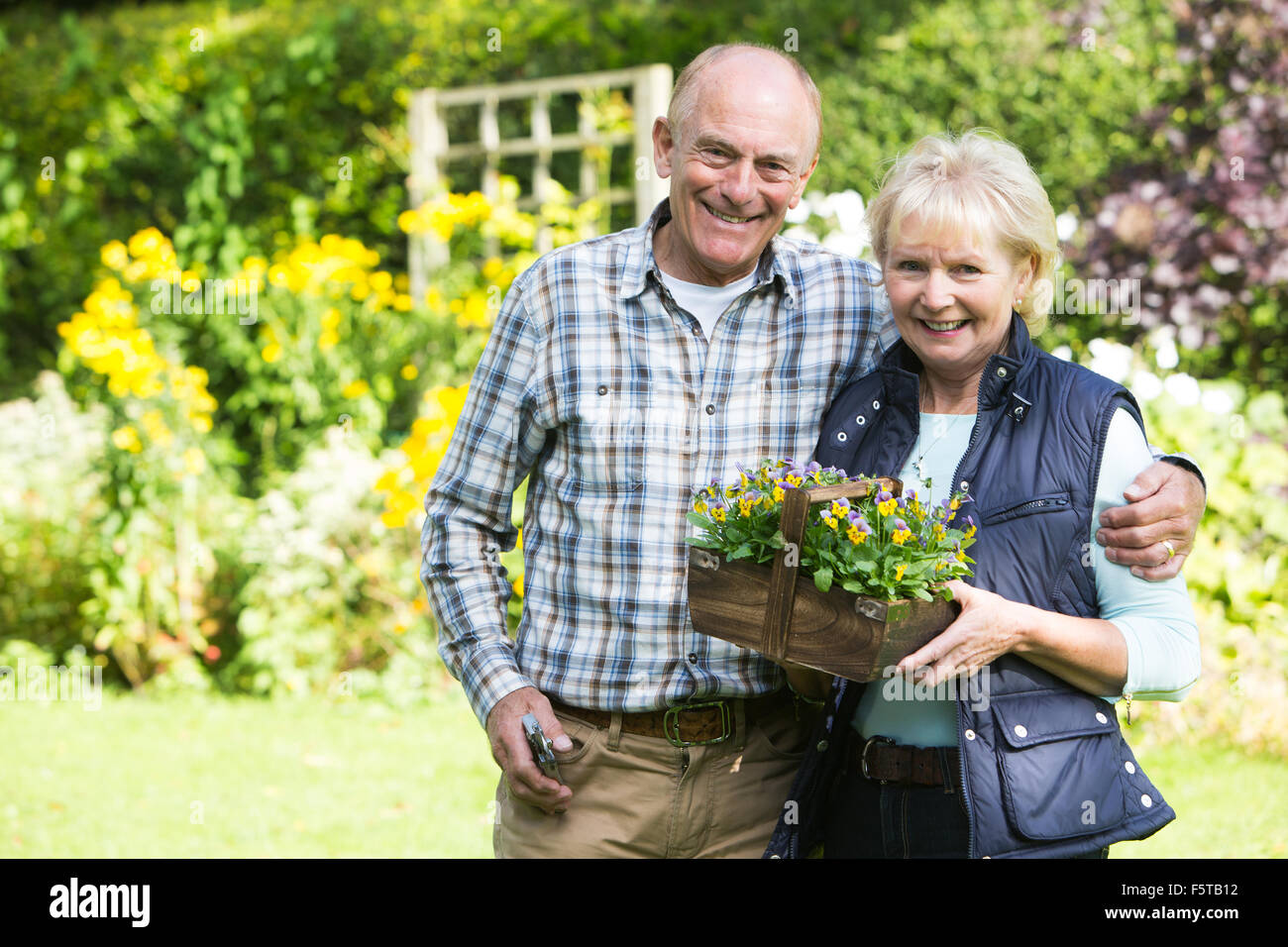 Portrait Of Senior Couple Working In Garden Together Stock Photo
