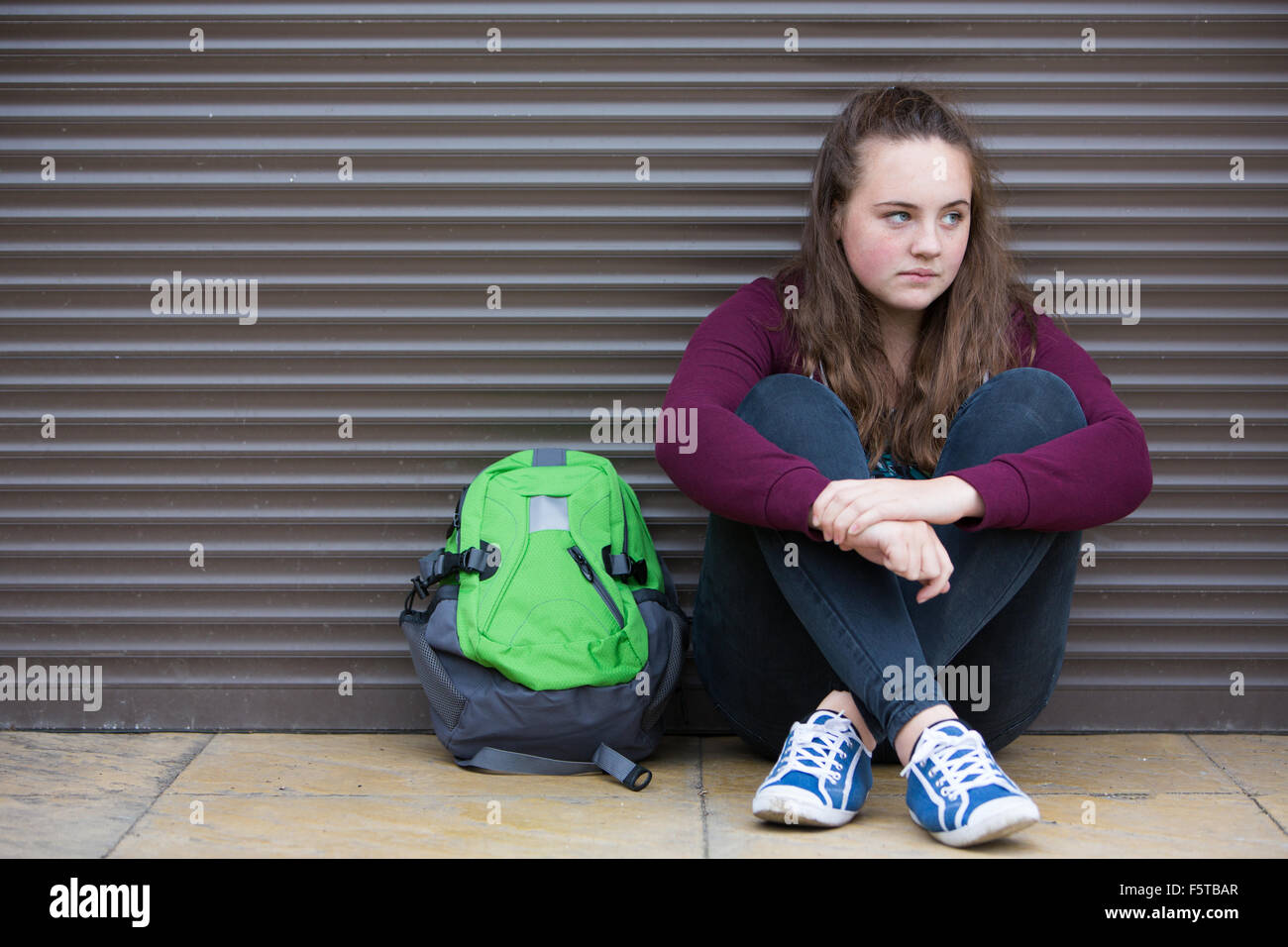Homeless Teenage Girl On Streets With Rucksack Stock Photo