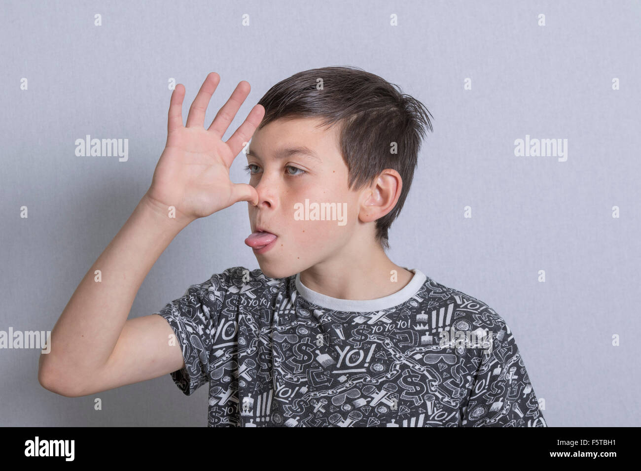 Pre-teen boy sticking his tongue out Stock Photo