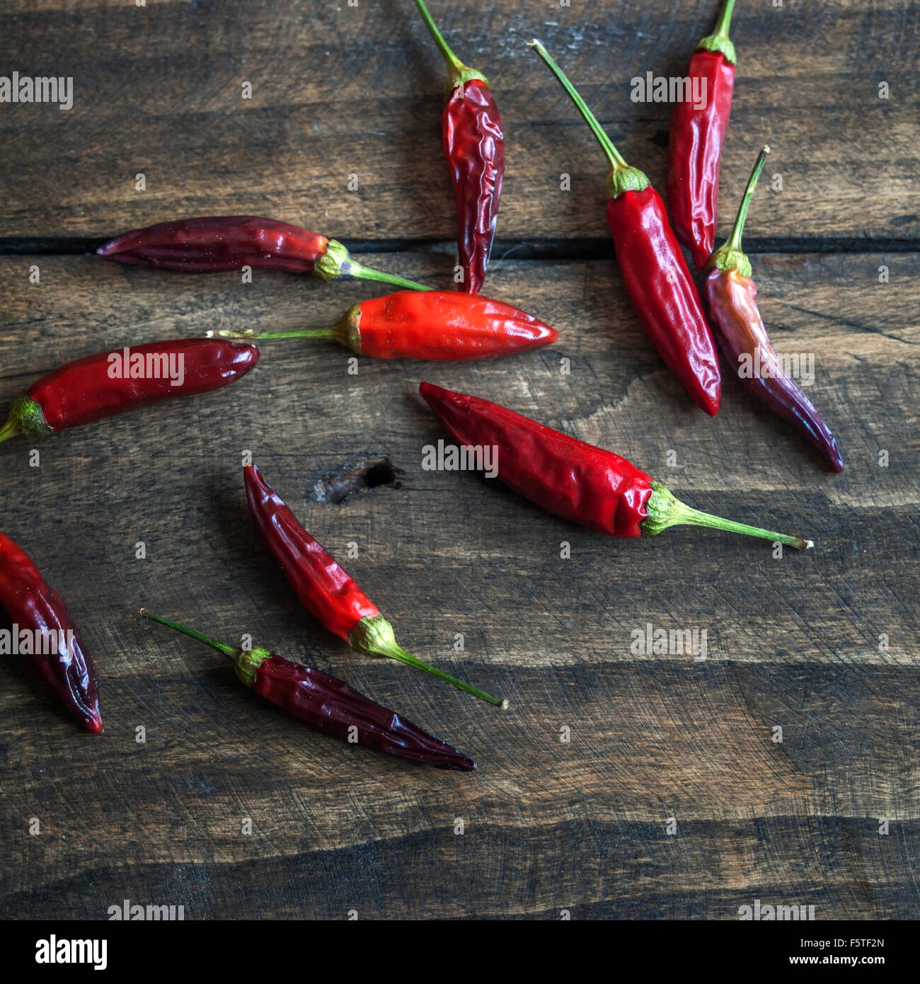 Red hot chili peppers on old wooden table, natural light Stock Photo ...